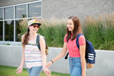 two students walking and laughing