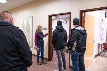 a group tour looks into a classroom