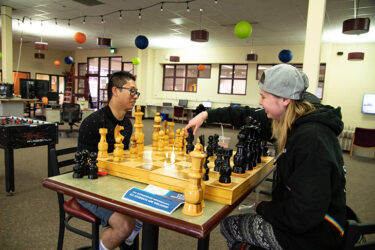 Students play chess in lounge