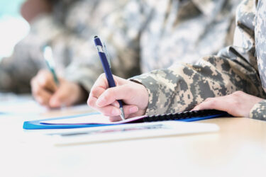 a person in uniform holding a pen
