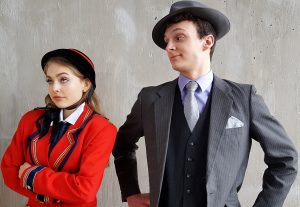 man and a woman posing, theatre students wearing 1940s garb