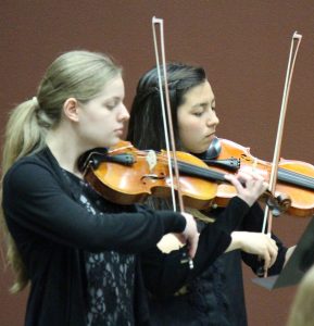 two music students playing violin