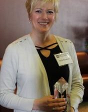 Heidi Emerson portrait holding an award