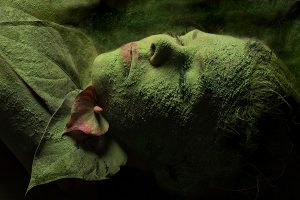 Gregg Barckholtz artwork depicting person with eyes closed lying down covered in green moss