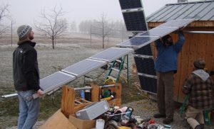 man lifting solar panel