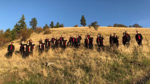 um chamber chorale group standing on a hill