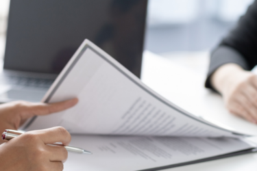 a persons hands on a printed resume