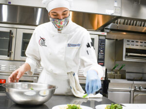 a culinary student prepares a meal