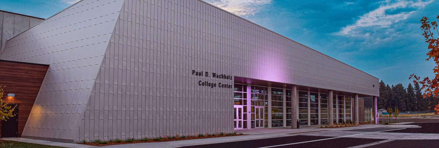 the paul d wachholz college center at dusk, a modern structure with steel and wooden construction