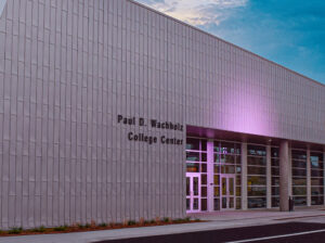the paul d wachholz college center at dusk, a modern structure with steel and wooden construction