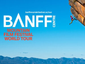 banff mountain film festival graphic featuring a climber scaling a red overhanging cliff with mountains and blue sky in the background