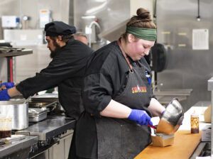 culinary students preparing at the Smolder pop-up restaurant