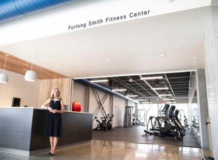 Lucy Smith stands in front of the new wachholz college center gym