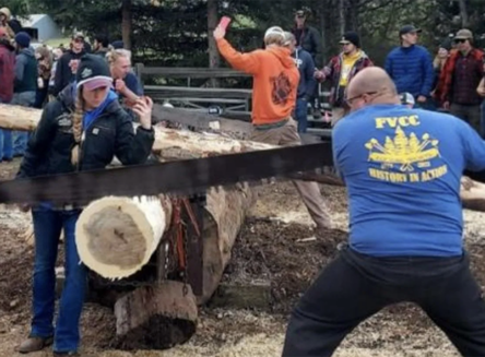 Seth Buckman sawing a log during a logging sports event