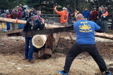 fvcc logger sports students cutting a log in a logging competition