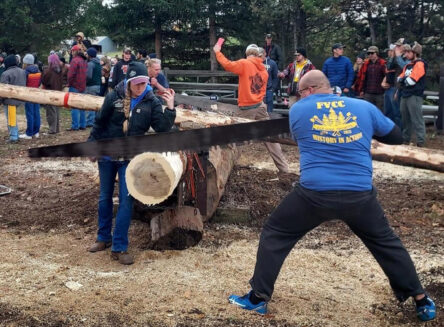 fvcc logger sports students cutting a log in a logging competition