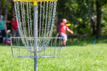 players playing disc golf