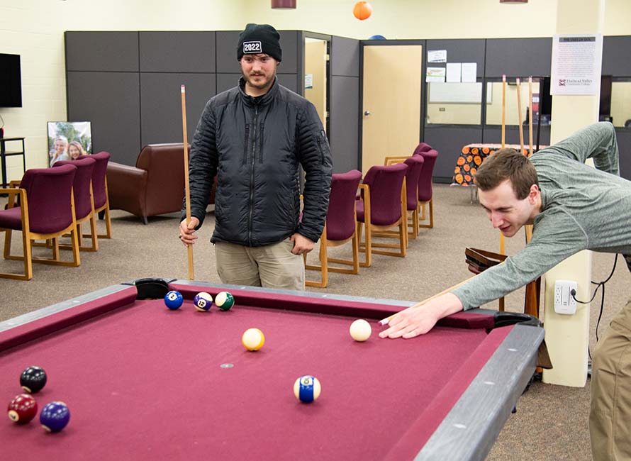 students playing pool in the student lounge