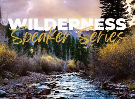 A square graphic with a nature landscape background, featuring a flowing river, rocky riverbed, trees, and mountains in the distance. The text WILDERNESS Speaker Series is overlayed on the image in a white, stylized font. The scene appears to be an outdoor setting, possibly a mountain stream. The colors are muted, with tones of brown, gray, green, and blue.