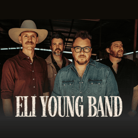 A photo of the four members of the Eli Young Band. The lead singer, wearing a denim shirt and glasses, is in the foreground, with the other three band members standing behind him. The name "ELI YOUNG BAND" is in large white text below the group.