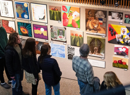 people looking at art hung up in the student exhibition