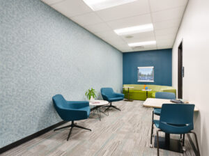 multi-use space with chairs at small tables and a couch