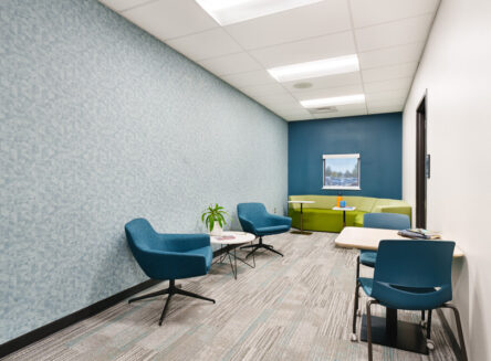 multi-use space with chairs at small tables and a couch