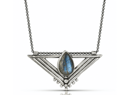 A detailed silver necklace featuring a triangular geometric pendant. The pendant holds a teardrop-shaped blue labradorite stone and is suspended from a delicate silver chain.