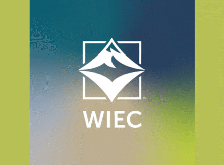The logo for the Wachholz Innovation and Entrepreneurship Center featuring a white mountain peak icon inside a square frame above the letters WIEC, centered on a blue and green gradient background.